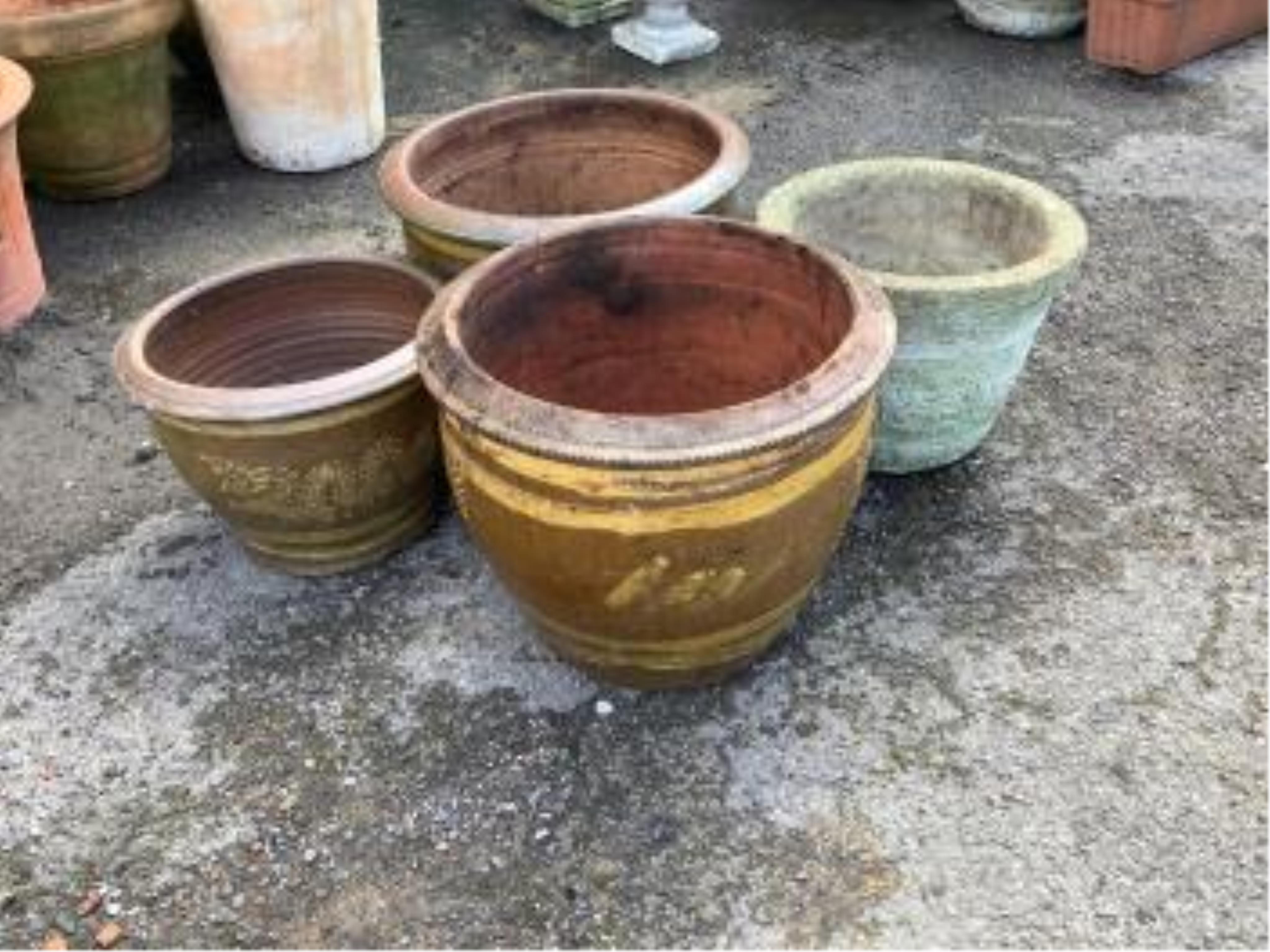 A collection of assorted glazed pottery garden pots and ornaments, largest diameter 42cm. Condition - all used and weathered but essentially fair